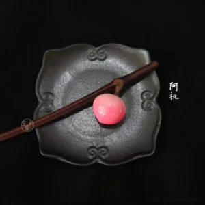 Peach blossom Chinese hair stick flat lay on a vintage black tray, dark brown branch-style Hanfu hair accessory with pink white peach decoration