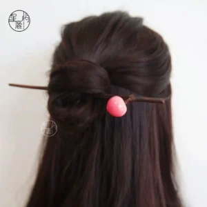 Peach blossom Chinese hair stick worn in a half-up hairstyle, featuring a dark brown branch-inspired pin and gradient pink white peach ornament for Hanfu