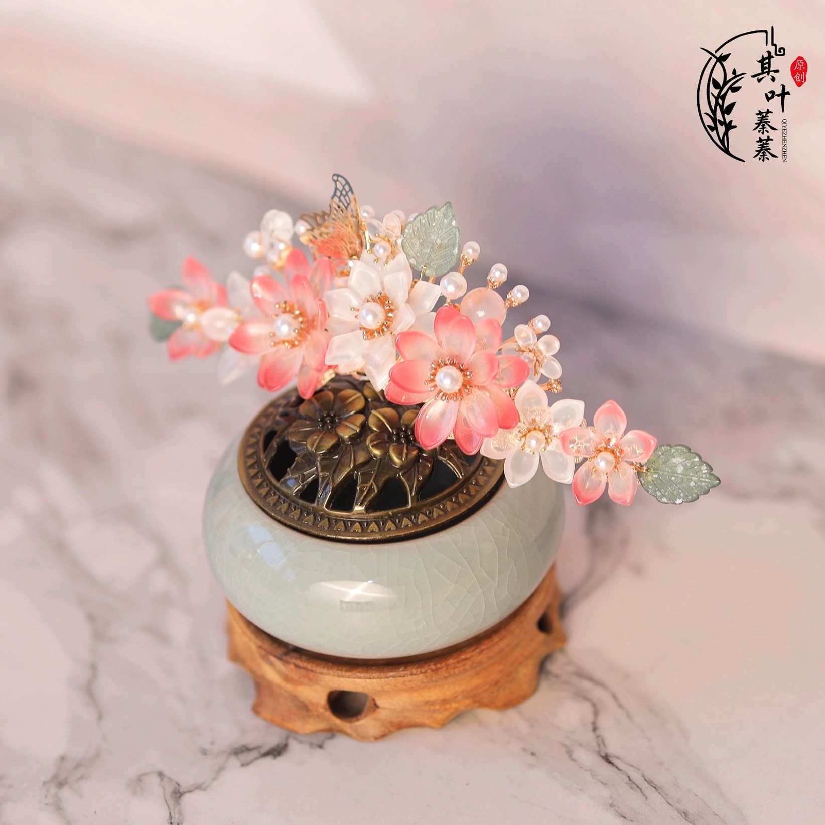 Side view of peach blossom floral Hanfu hair accessory featuring layered glass flowers, pearl accents and green leaves