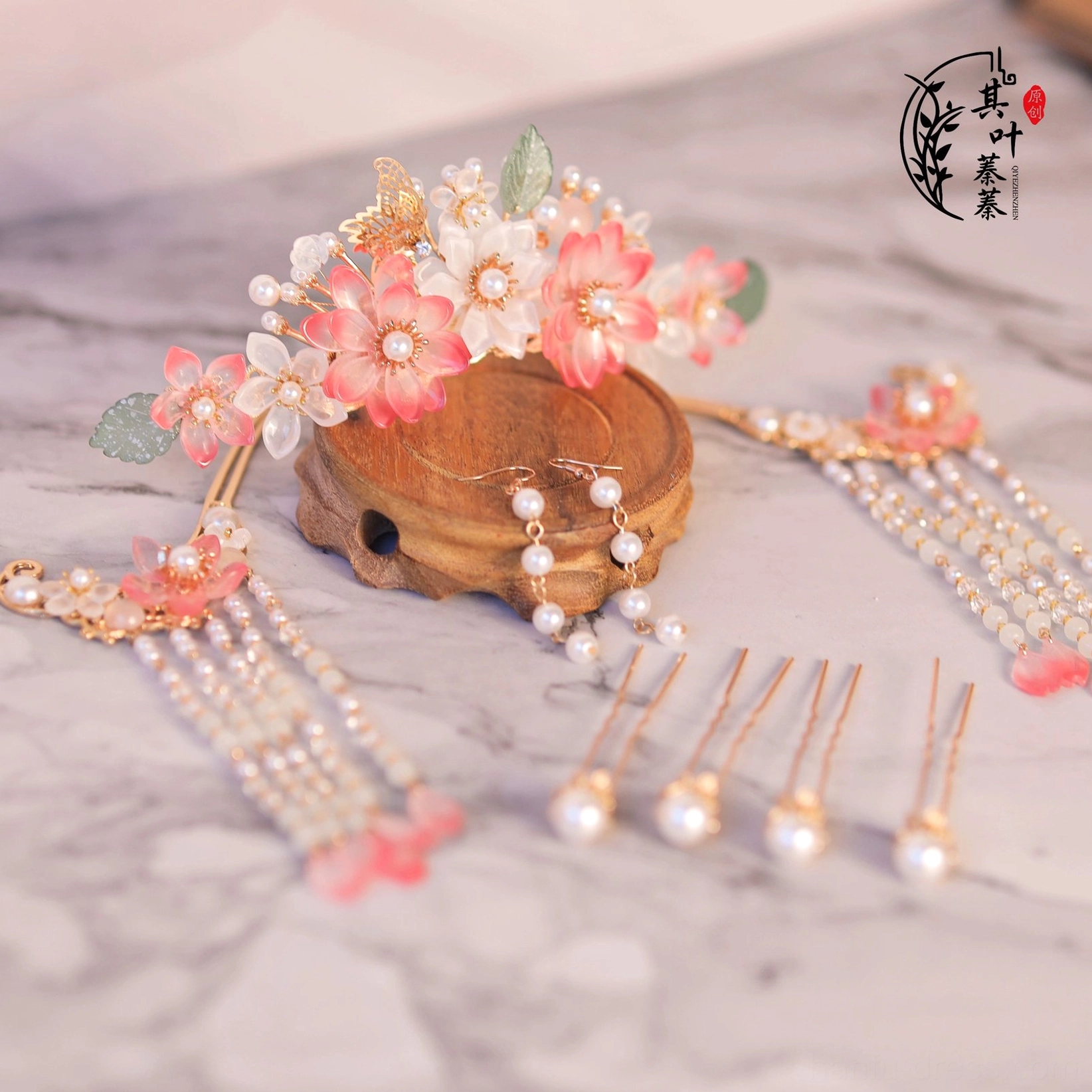 Complete peach blossom Hanfu hair accessory set displayed in a flat lay with pink and milky white glass flowers, pearl accents, gold tone fittings, green leaves, hairpins and tassels