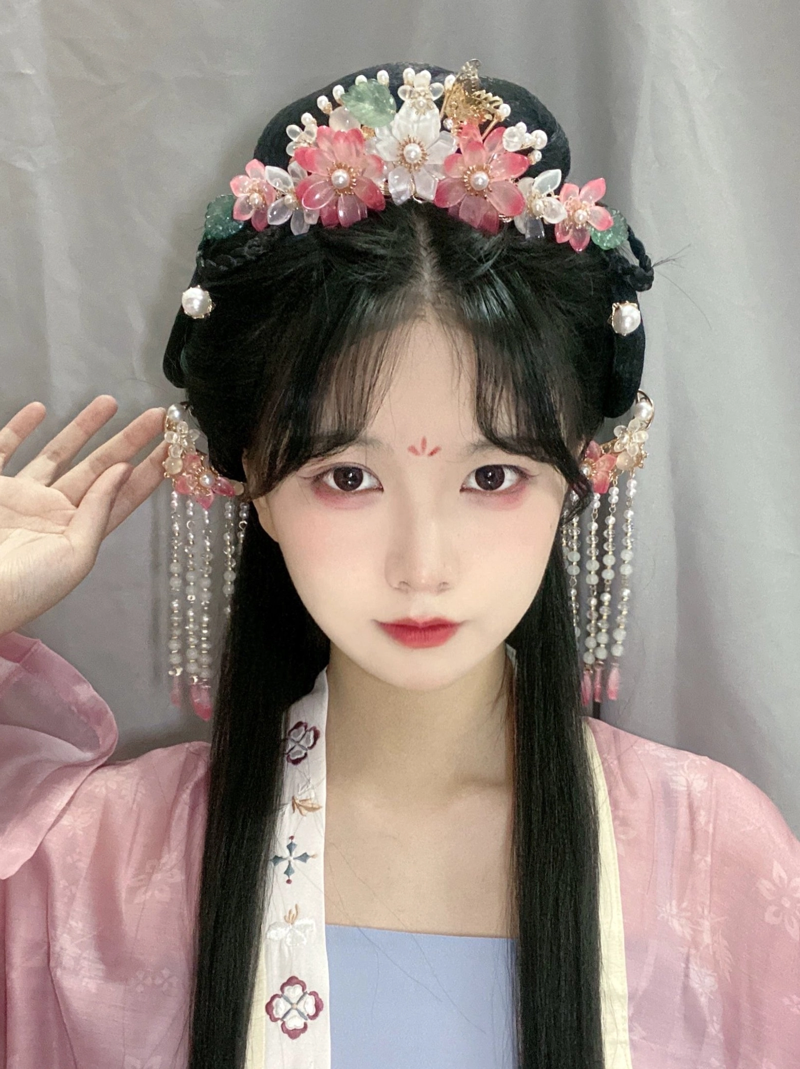 Front view of peach blossom Hanfu hair ornaments worn with an elegant traditional Chinese hairstyle and pink Hanfu dress