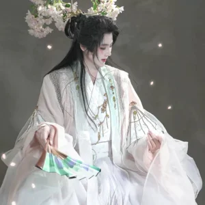 Close up front view of pink and white Hanfu upper body showing traditional cross collar golden embroidery wide sleeves peach blossom hair crown and folding fan