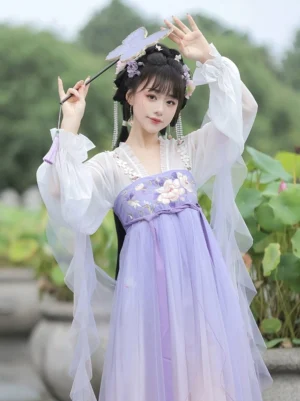 Front view of Peach Fairy Tang Dynasty style Hanfu qixiong ruqun with pearl trimmed neckline, translucent lantern sleeves, floral embroidery and purple sash
