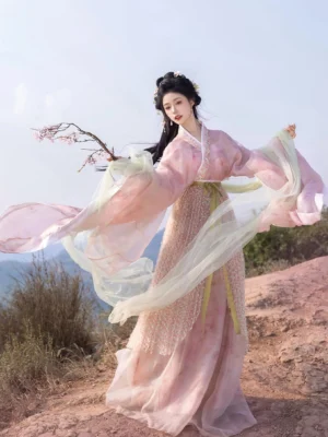 Three-quarter view of Peach Oolong Wei Jin Dynasty Hanfu with flowing pink sleeves, pale green translucent ribbons, textured wrap skirt and elegant fantasy-inspired silhouette