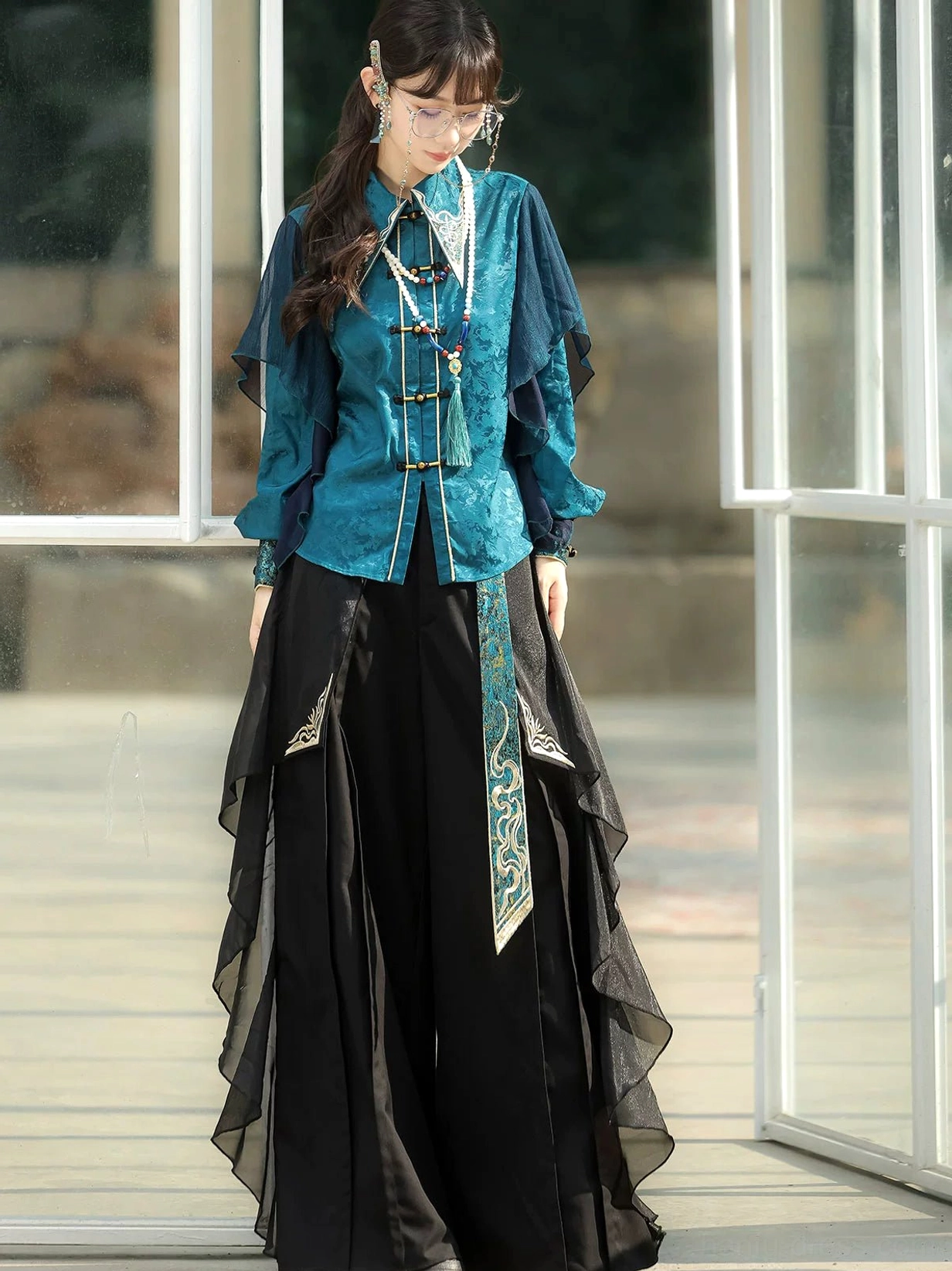 Peacock blue Chinese style blouse and wide-leg pants without vest showing frog buttons and embroidered waist detail