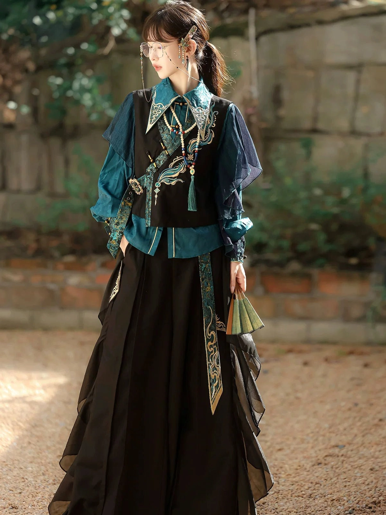 Front angled view of peacock blue phoenix embroidered Modern Hanfu set with vest and layered sheer pants