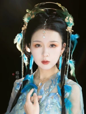 Peacock Queen Chinese Hanfu hair accessory set on model with feather side ornaments, flowing beaded tassels, halo crown, and coordinated necklace styling