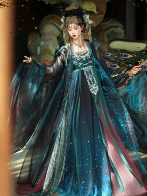 Front-left view of a peacock-themed Tang Dynasty Hanfu Heziqun complete set with sheer wide sleeves, embroidered bodice, shimmering gradient skirt, layered ribbons, and Dunhuang-inspired styling