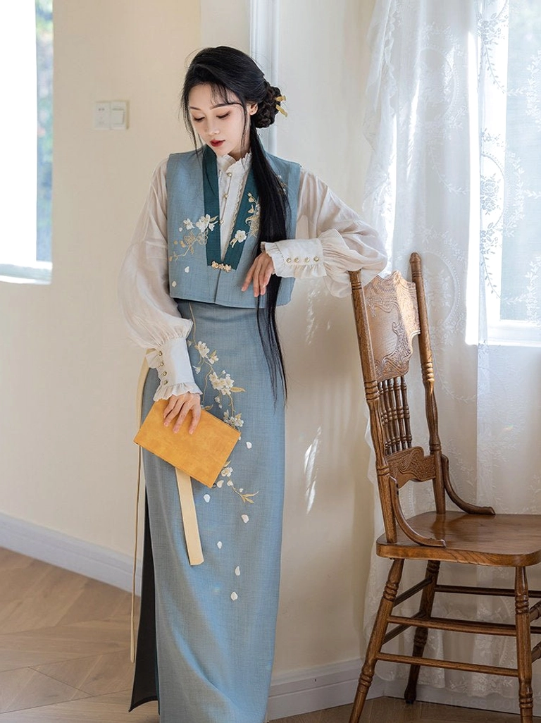 Side view of a woman wearing a Pear Blossoms Chinese style Hanfu dress set with embroidered vest, lantern sleeves, and flowing wrap skirt