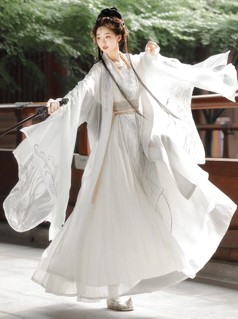 Dynamic Song Dynasty qiyao ruqun Hanfu outfit with wide fluttering white sleeves, embroidered floor-length skirt and traditional sword