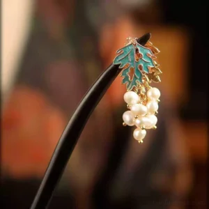Close-up of a handmade pearl grape Chinese hair stick with dark wooden rod, cyan enamel leaf, gold-tone details, and clustered imitation pearl pendant