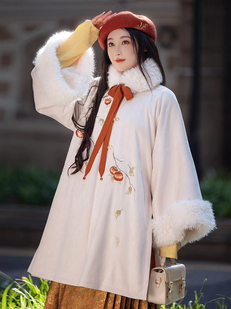 Front three-quarter view of persimmon Ming Dynasty Hanfu coat set with gold brocade Mamianqun skirt