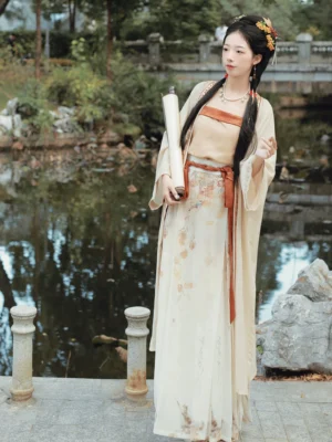 Full-body persimmon Song Dynasty Hanfu outfit featuring a cream flowing beizi, terracotta trim, high-waisted printed skirt, and coordinated warm-toned layers beside a traditional waterside stone garden