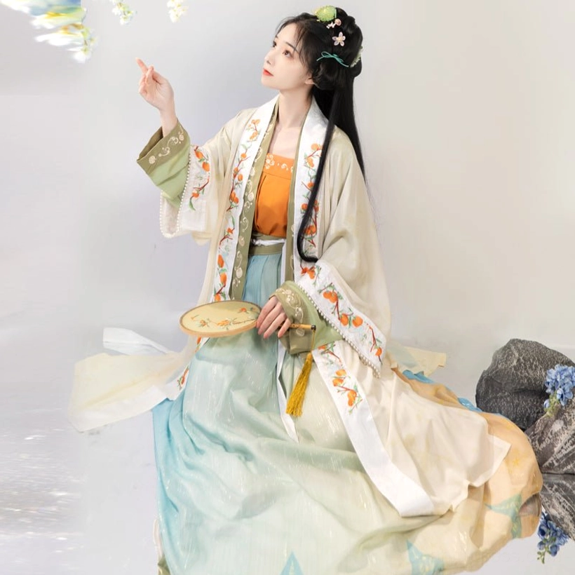 Persimmon themed Song Dynasty hanfu three quarter view with green cuffs embroidered outer coat and qiyao ruqun skirt
