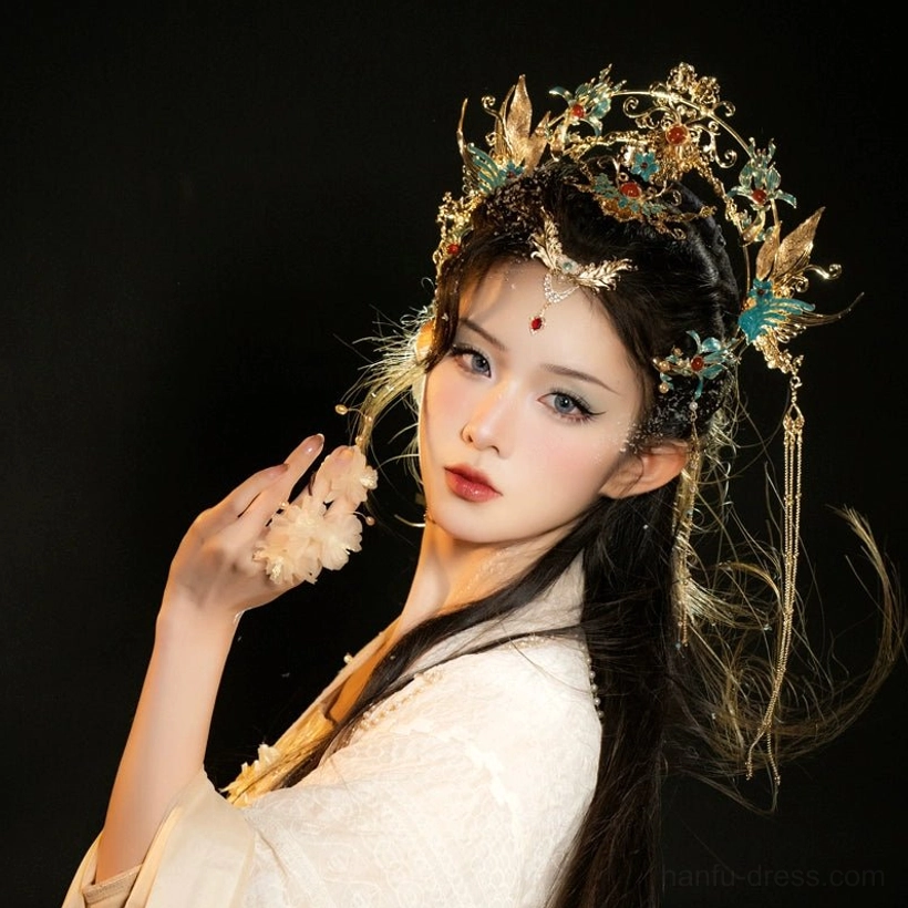 Side view of turquoise phoenix Hanfu crown with long tassels worn with traditional Chinese hairstyle and beige Hanfu