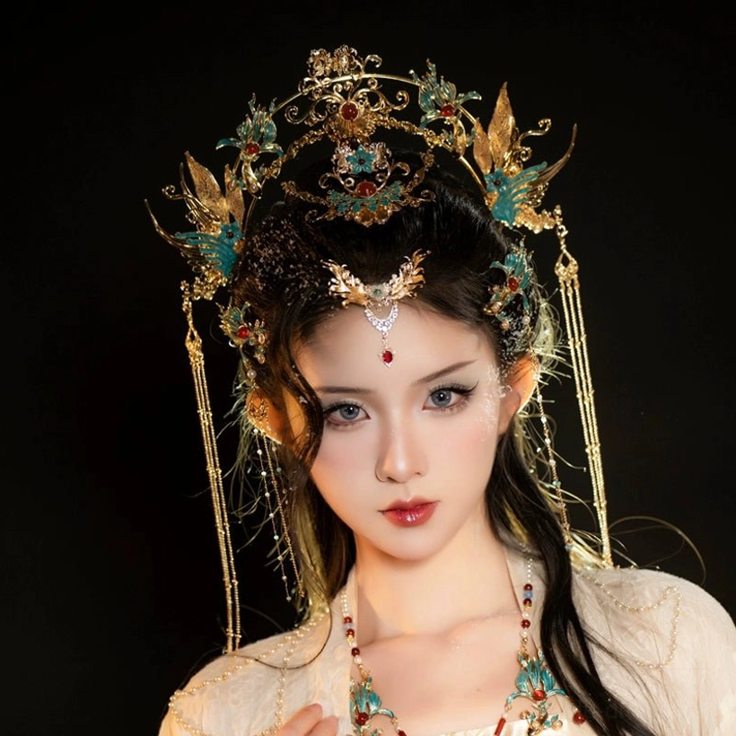 Gold-tone phoenix Hanfu hair crown with red decorative inlays and long chain tassels on white background