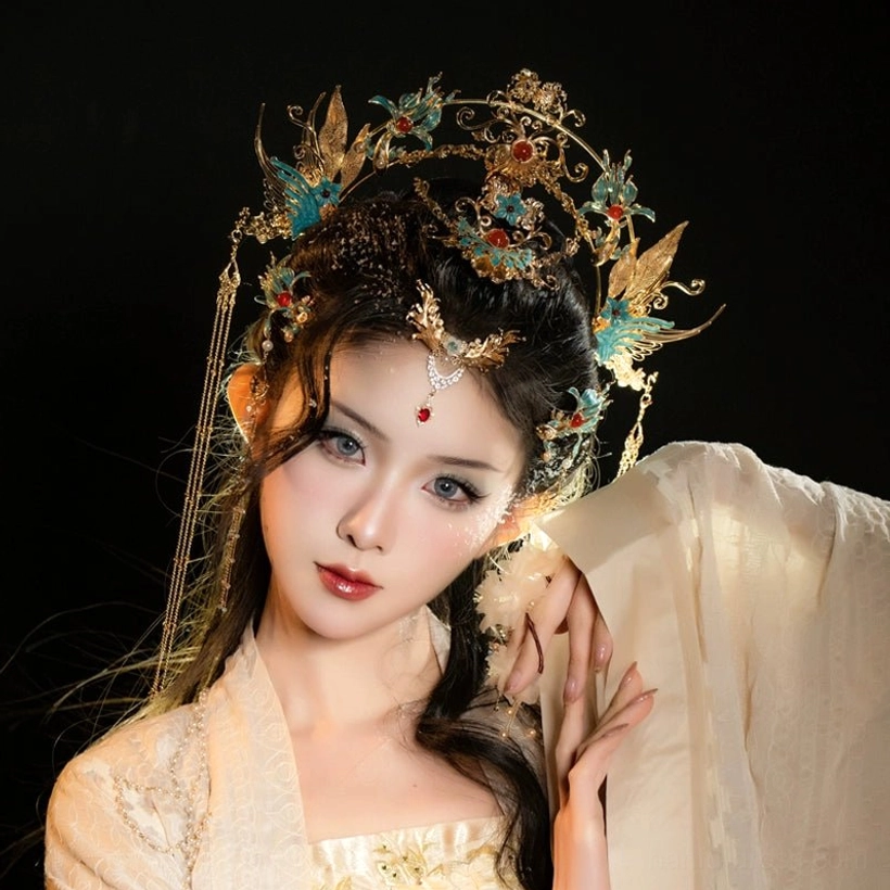 Close-up front view of ornate phoenix Hanfu headpiece with symmetrical tassels and forehead pendant on model
