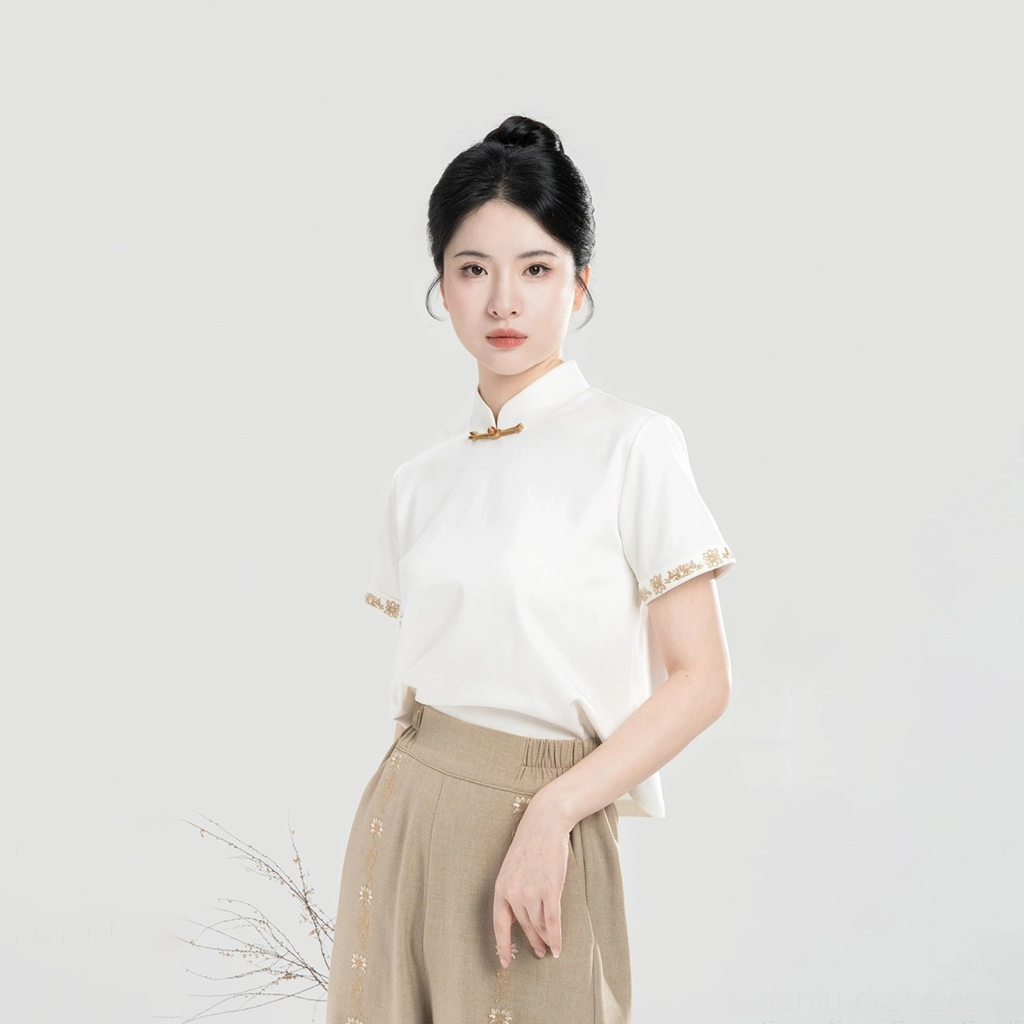 Ivory short sleeve modern Hanfu top with stand collar frog closure and delicate embroidered cuff details