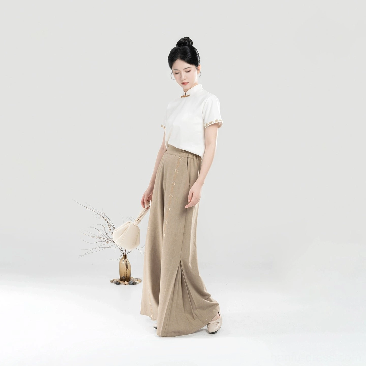 Khaki wide-leg pants from Pinewood modern Hanfu set paired with ivory Mandarin collar short sleeve top