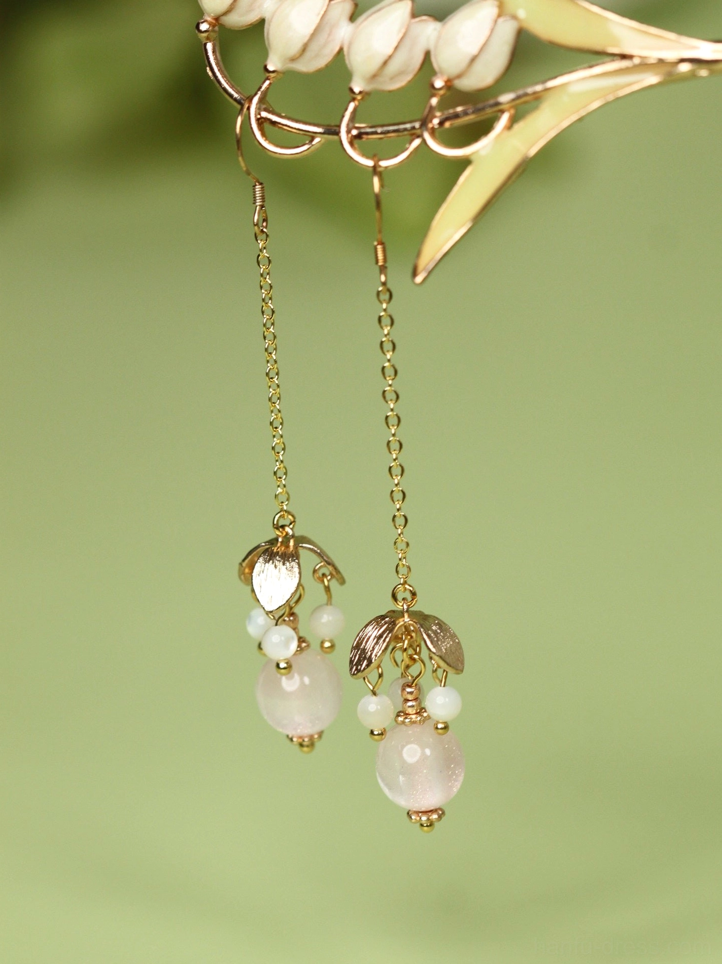 Detailed front view of pink beaded Hanfu dangle earrings featuring fine gold chains, ornamental charms, and pearl-like white beads
