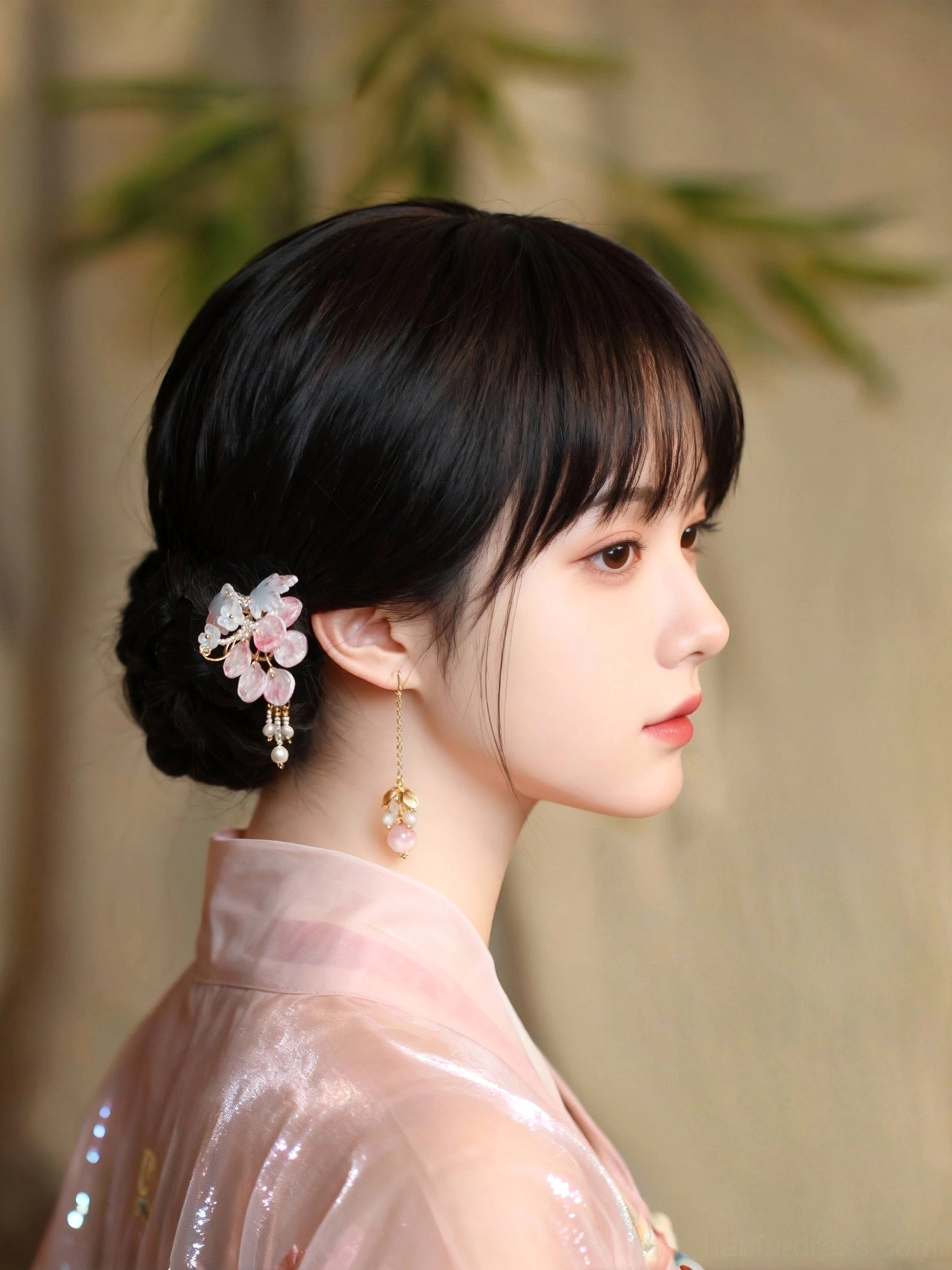 Woman wearing pink beaded long dangle Hanfu earrings with a pink traditional Chinese Hanfu outfit and elegant updo hairstyle