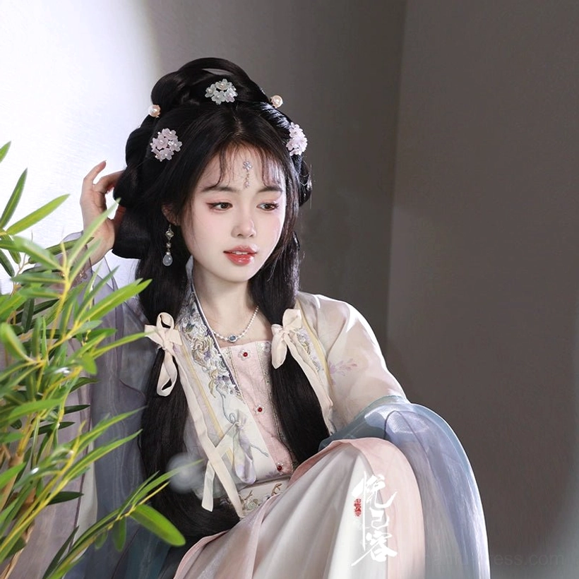 Side view of woman in pink and blue Song-style Hanfu wearing a hydrangea flower hair pin with traditional earrings and necklace