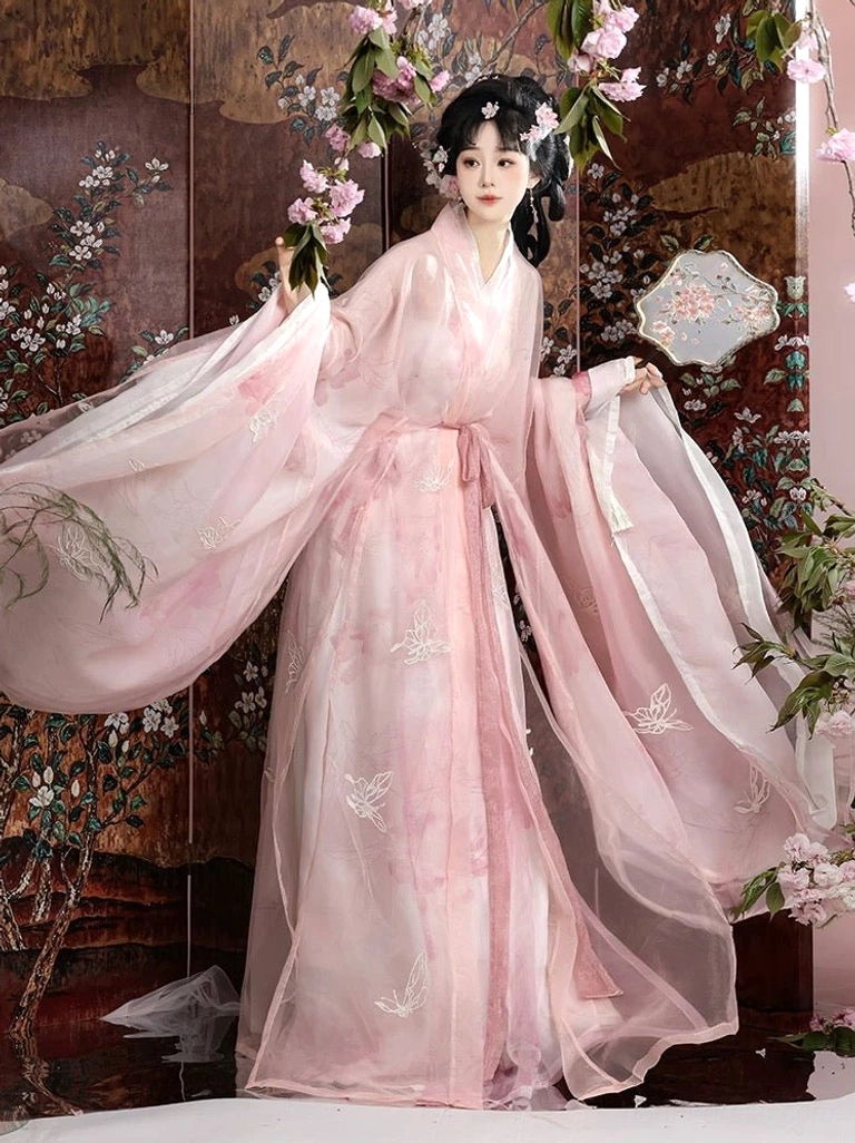 Side three-quarter view of pink embroidered butterfly Hanfu costume with sheer flowing robe layers and traditional cross-collar silhouette