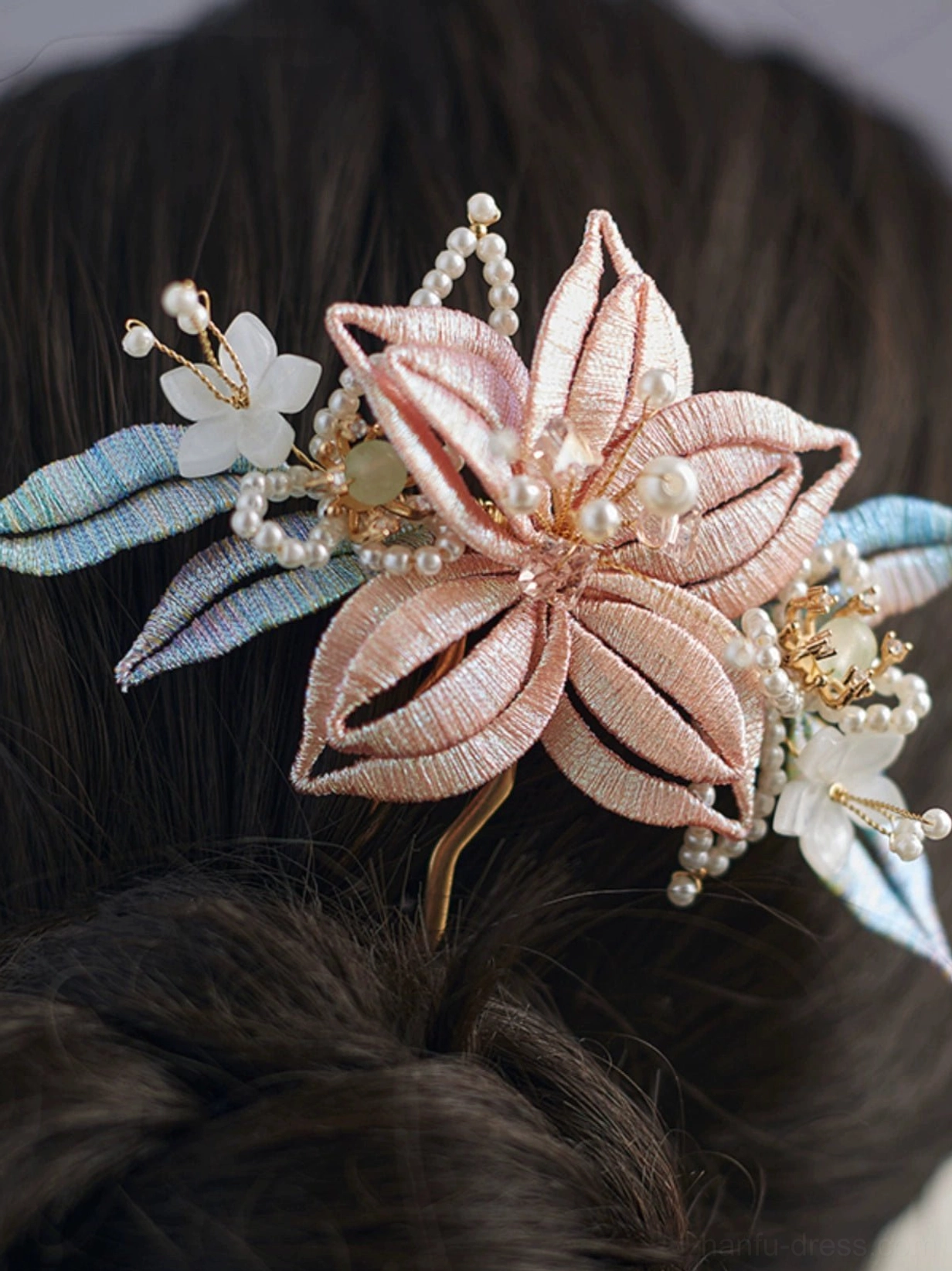 Pink Chanhua floral Hanfu hairpin with gradient blue leaves, faux pearl clusters, white flowers and gold tone hair fork styled in a low twisted bun