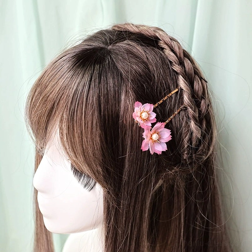 Pink cherry blossom hanfu hair pins styled on a side braid for a romantic traditional Chinese inspired hairstyle