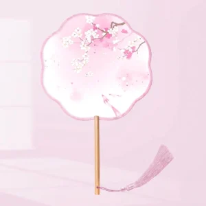 Pink traditional Chinese round hand fan with scalloped edge, cherry blossom and koi design, smooth wooden handle, and matching tassel on a light pink background