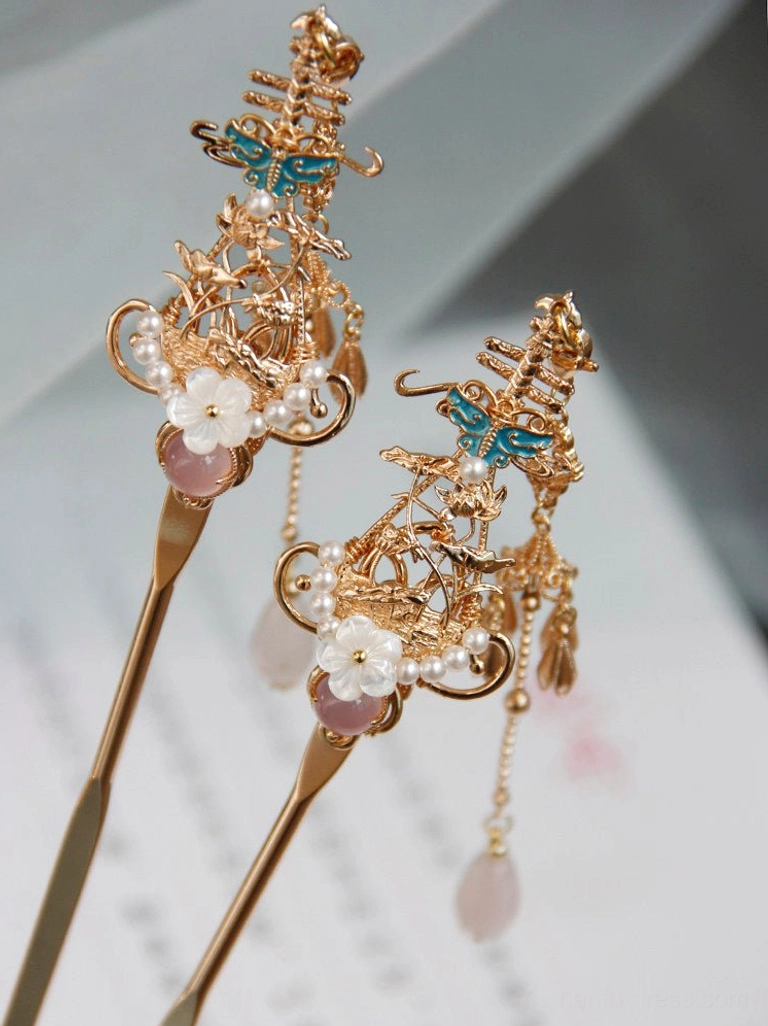 Pink Chinese hair stick with pink gemstone setting, white floral ornament, blue enamel accent and light pink teardrop tassel
