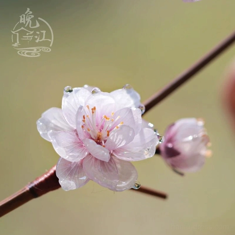 Pink Chinese hair stick featuring a plum blossom with yellow stamens dewdrops small flower bud and dark brown wooden shaft