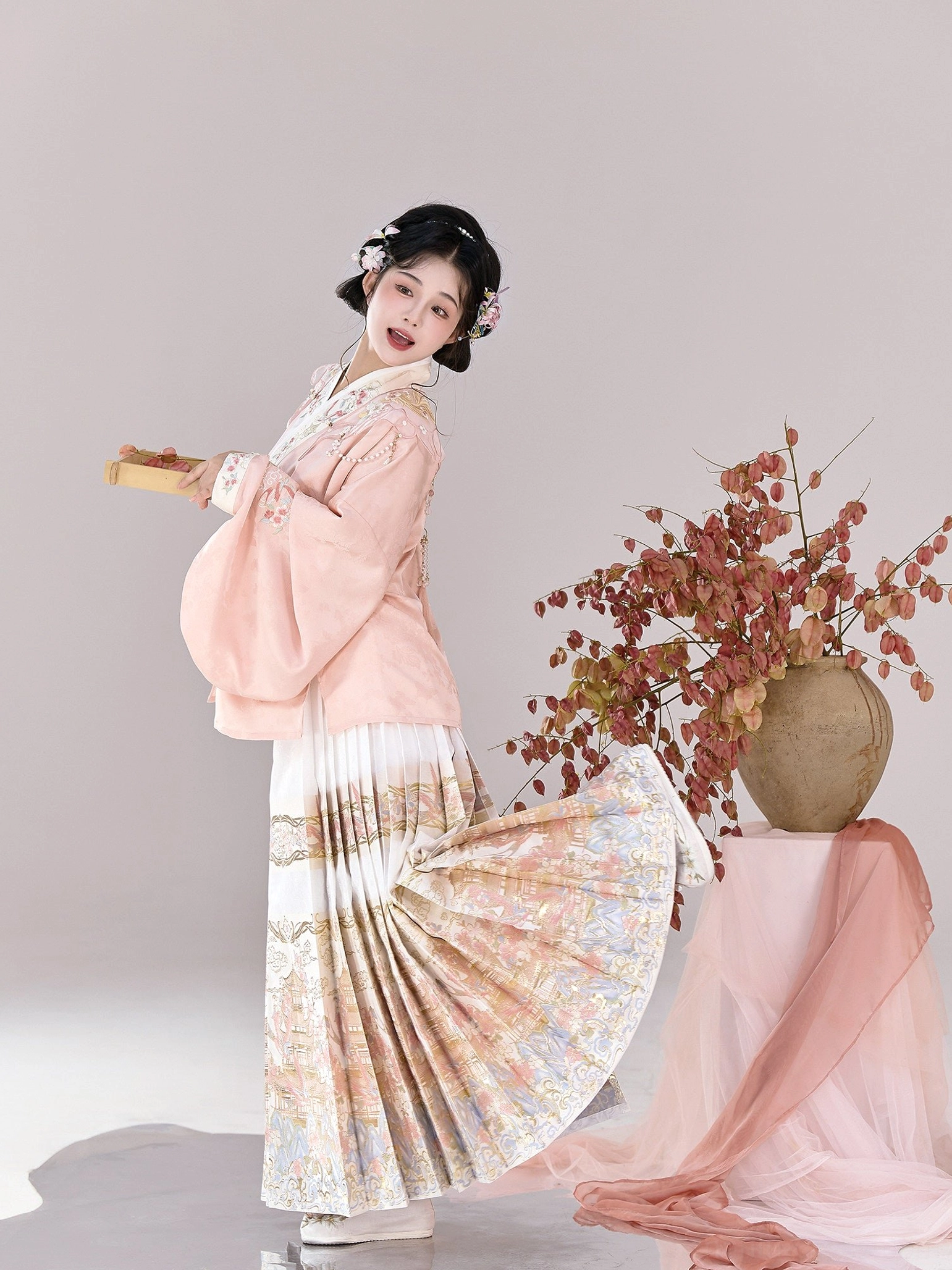 Ming Dynasty Hanfu pink cross collar pipa sleeve top and white pleated mamianqun showing landscape hem print
