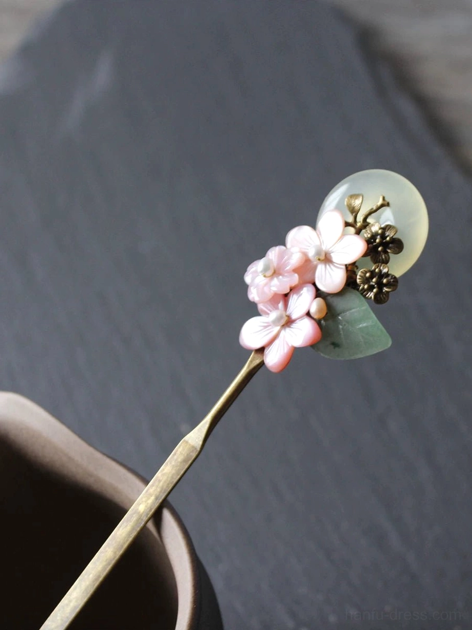Pink floral full moon Chinese hair stick with jade-inspired round pendant, green leaves, antique bronze details, and brass hairpin shaft for Hanfu hairstyles