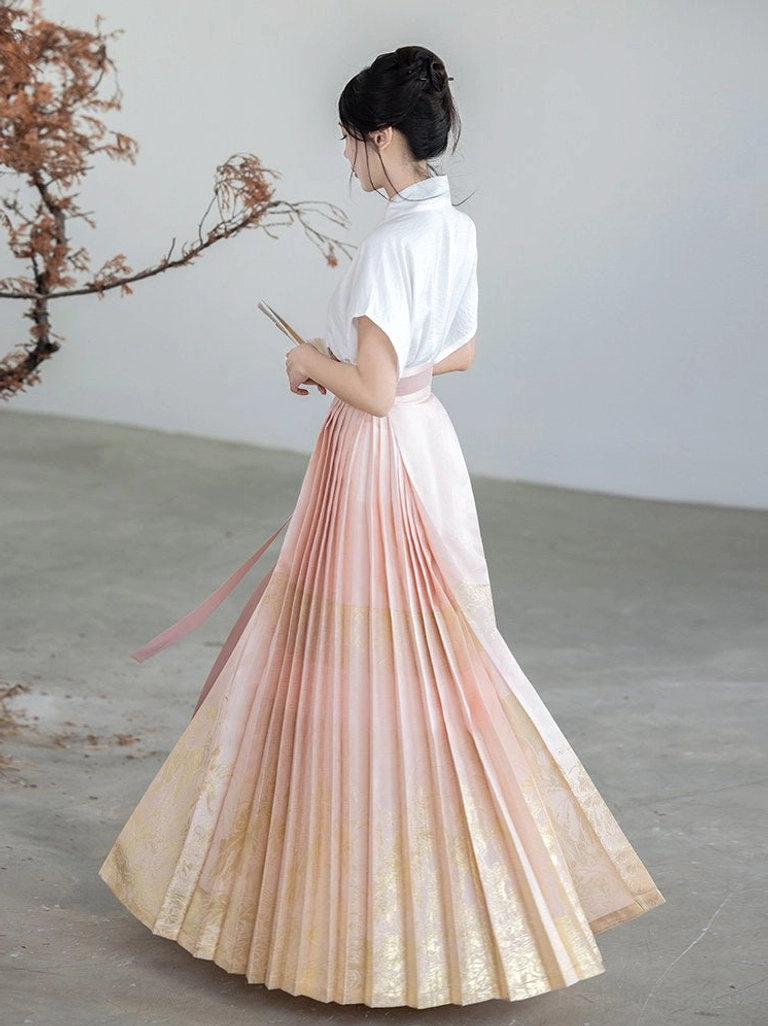 Back three-quarter view of pink gold gradient pleated Ming Dynasty mamianqun skirt with matching waist ties