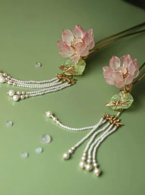 Pair of pink lotus tassel hair pins with translucent glass flowers green leaves gold-toned metal shafts rice bead strands and round pearl pendants for Hanfu hairstyles