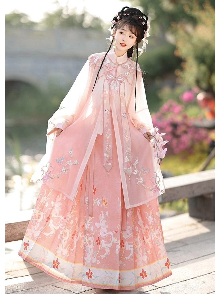 Pink Ming Dynasty Hanfu set with delicate floral embroidery across the robe and mamian skirt modeled in a serene waterside Chinese garden