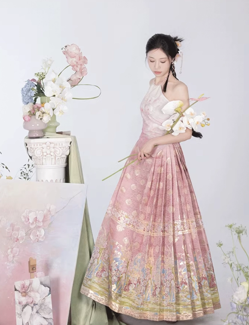 Side view of pink Ming-inspired modern Hanfu mamian skirt with halter top, pleated silhouette, and decorative trim