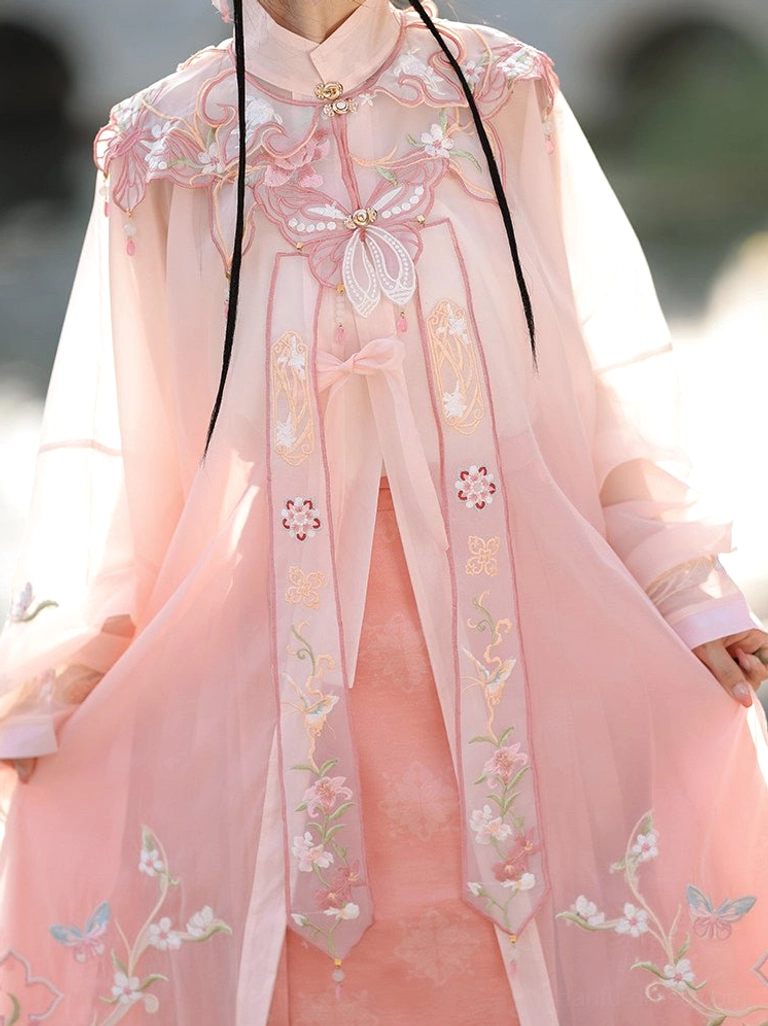 Close-up of pink Ming-style Hanfu stand collar blouse with sheer fabric, butterfly and floral embroidery, and elegant traditional neckline