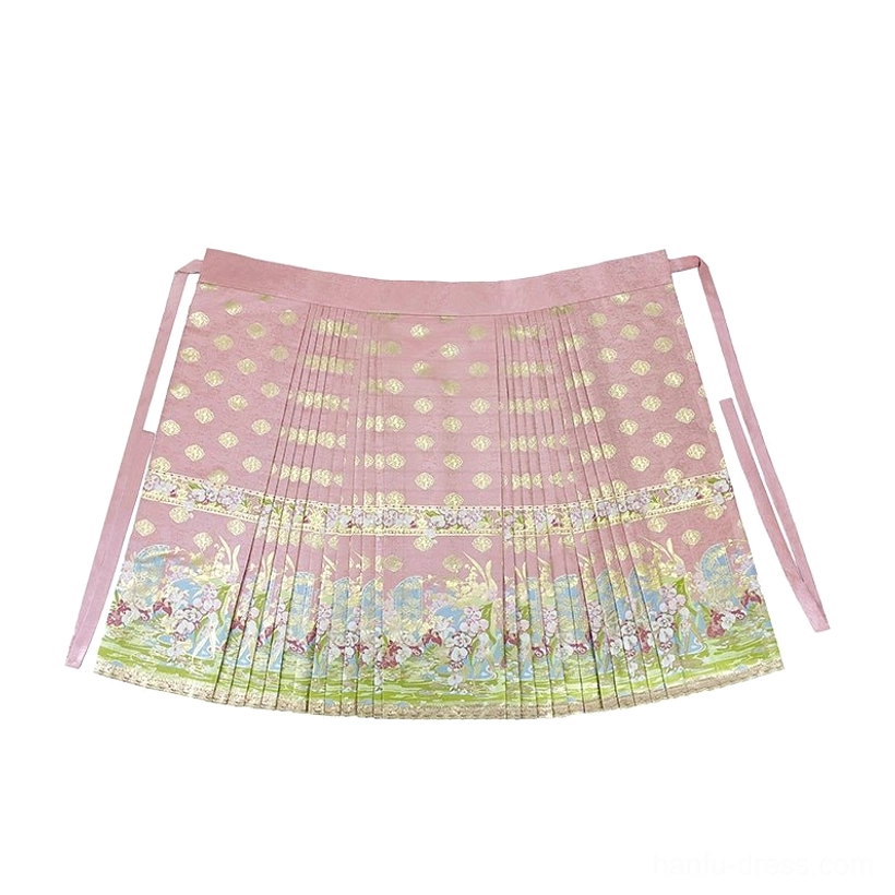 Flat lay of pink Ming Dynasty-inspired modern Hanfu mamian skirt with golden round prints, green hem border, pleats, and adjustable side ties