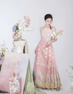 Full body model wearing pink modern Hanfu mamian skirt with fitted halter top and golden decorative hem