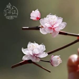 Pink plum blossom Chinese hair stick with translucent resin petals dewdrop accents and dark brown wooden shaft displayed on a decorative branch