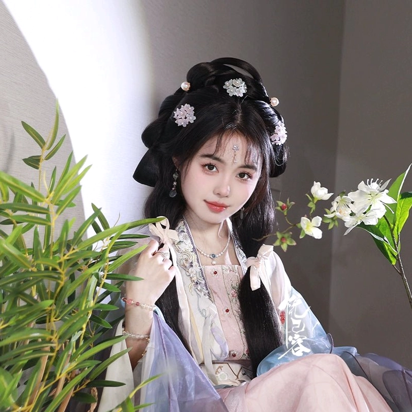 Woman in pink and purple Song-style Hanfu with a delicate hydrangea hair ornament and classical Chinese-inspired makeup