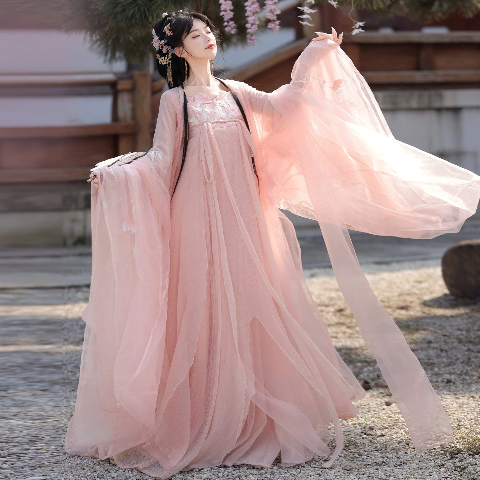Pink Tang Dynasty Qixiong Ruqun complete hanfu set shown from the side with lightweight sheer chiffon layers, wide flowing sleeves, embroidered neckline, and long hanging sash