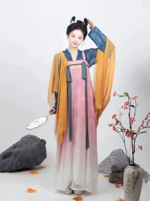 Front view of pink Tang Dynasty Qixiong Ruqun Hanfu with ivory gradient skirt dark green chest ribbons and yellow sheer shawl