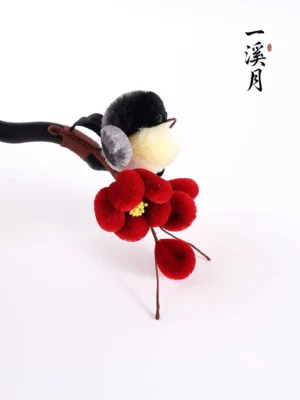 Top angled view of plum blossom bird Hanfu hair stick with clustered red flowers and curved dark hairpin
