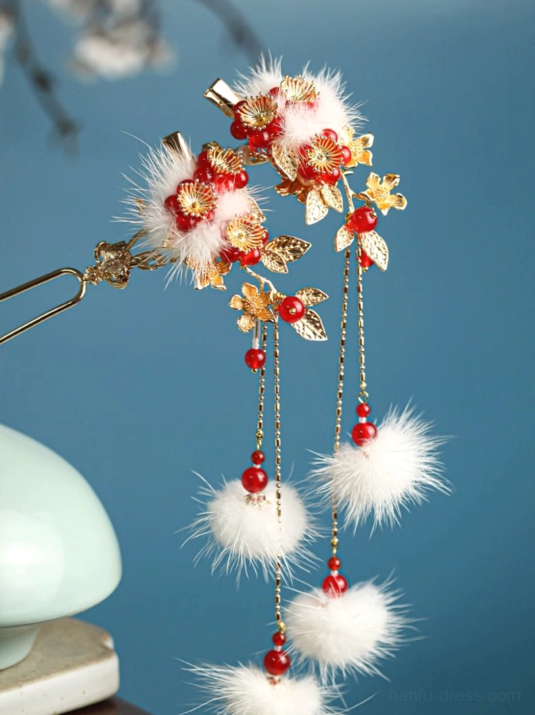 Traditional Chinese plum blossom Hanfu hair pin with gold-tone floral ornaments, white pom-poms, red beads, and layered dangling tassels on a blue background