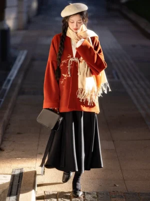 Modern Song Dynasty Hanfu autumn outfit with rust red embroidered jacket, black wrap skirt, cream scarf and beret in walking view