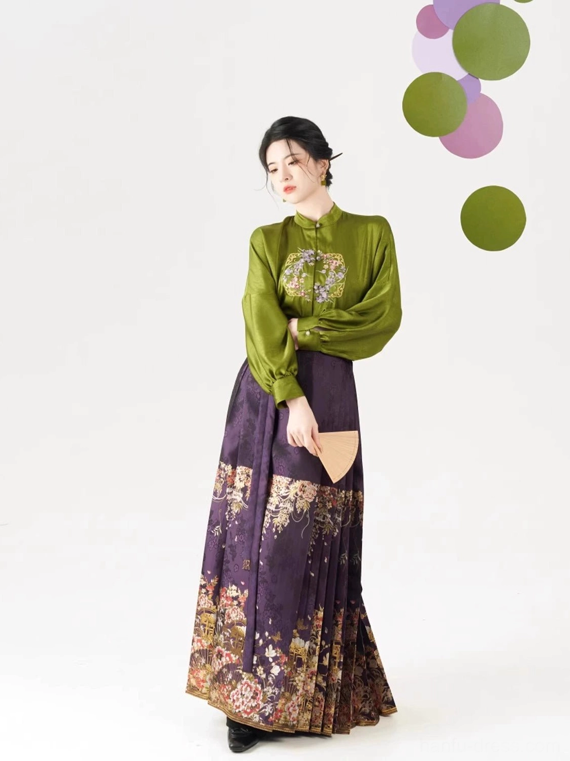 Front view of olive green Chinese Hanfu blouse and dark purple pleated mamian skirt outfit with floral printed hem