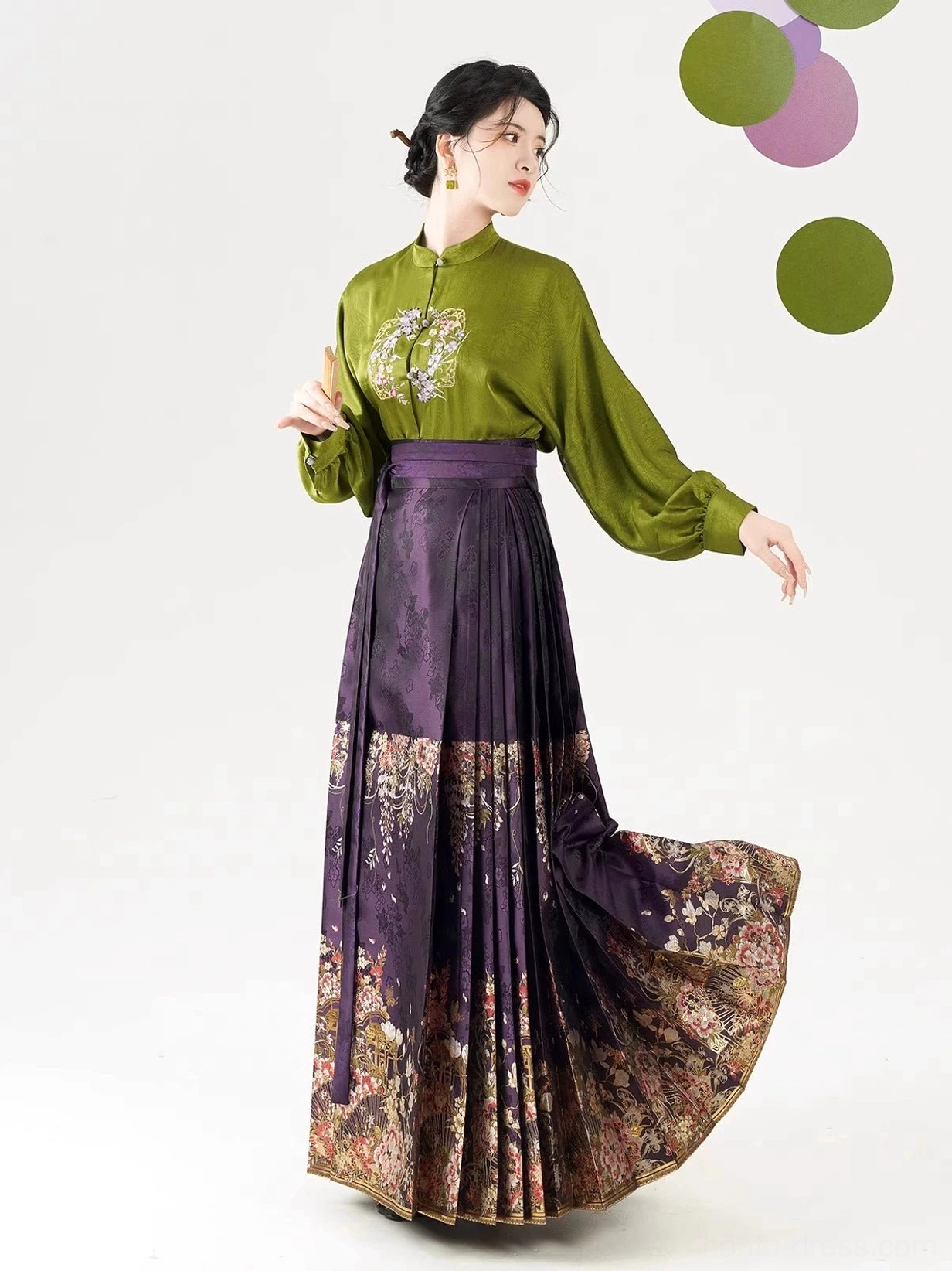 Olive green Ming Dynasty Hanfu blouse and flowing dark purple pleated mamian skirt showing movement and floral hem detail